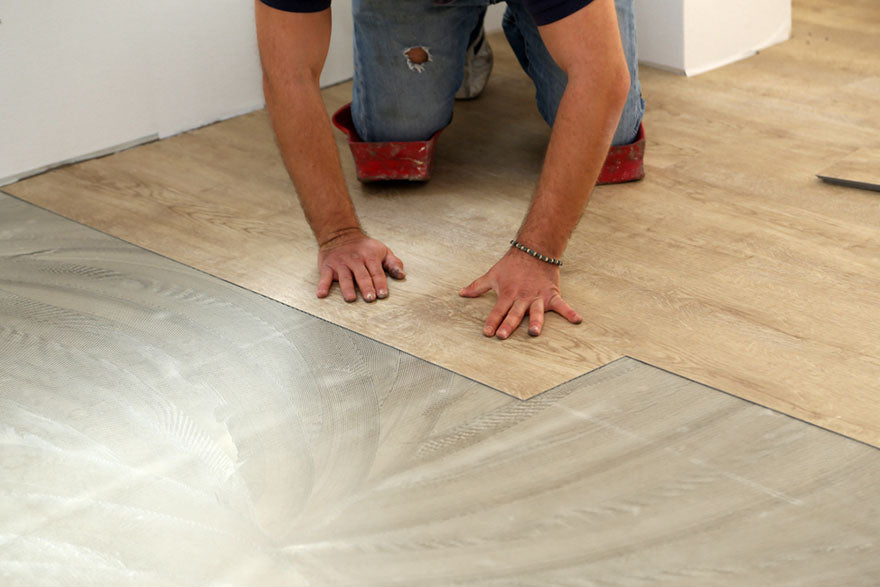 laying flooring worker installing