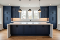 High-resolution modern kitchen with full-overlay Shaker or flat-panel cabinets painted in a deep navy blue similar to Sherwin-Williams Naval (SW 6244). Large island with waterfall white quartz countertops, matte black hardware, light wood floors, simple modern pendant lighting. Warm layered lighting with natural daylight accents, high-end dramatic feel, clean styling, no people, no text or branding.